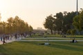 People at the opening of a modern leisure Park before sunset.